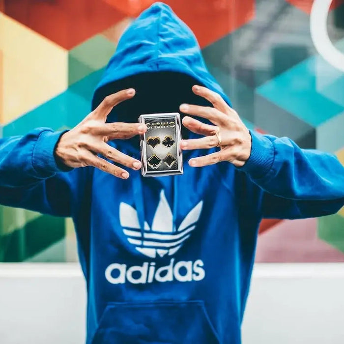 Person taking a selfie in urban city with Adidas style