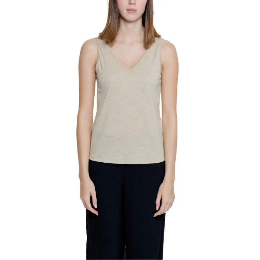 Beige sleeveless v-neck top paired with black pants by Jacqueline De Yong women undershirt