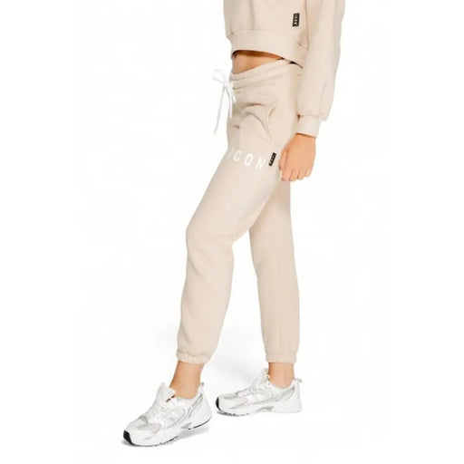 Beige sweatpants with drawstring waist paired with white sneakers from Icon Women Trousers