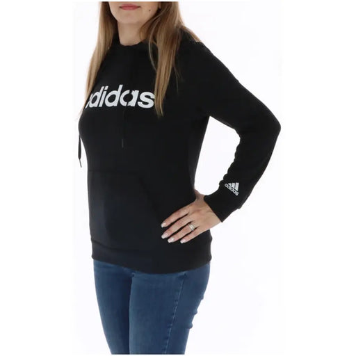 Woman in blue jeans wearing black Adidas sweatshirt from Adidas Women Sweatshirts collection