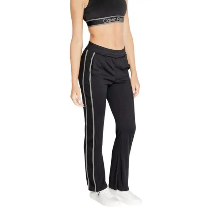 Black athletic pants with white side stripes from Calvin Klein Sport for women