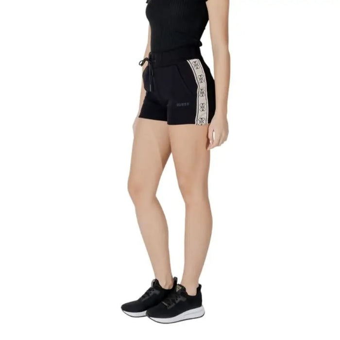 Black athletic shorts with logo stripe from Guess Active for women, featuring laces