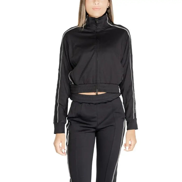 Black athletic tracksuit with cropped top and high-waisted pants by Calvin Klein Sport