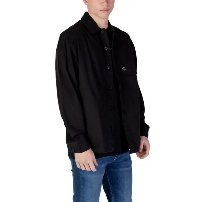 Black button-down shirt paired with blue jeans from Calvin Klein Jeans Men