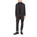 Black button-up overcoat styled with dark pants and boots in Jack & Jones Men Knitwear