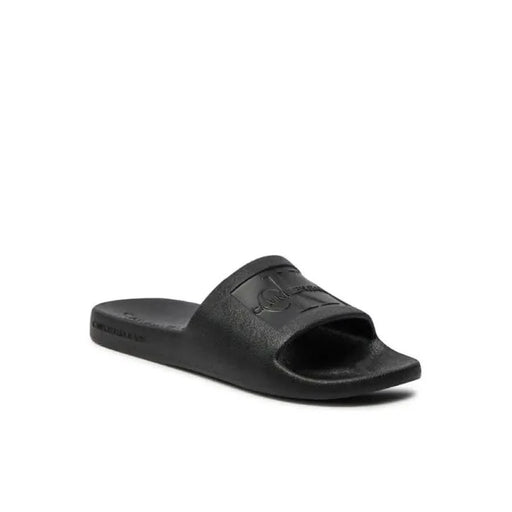 Black Calvin Klein slide sandal with embossed logo from Calvin Klein Jeans Women Slippers