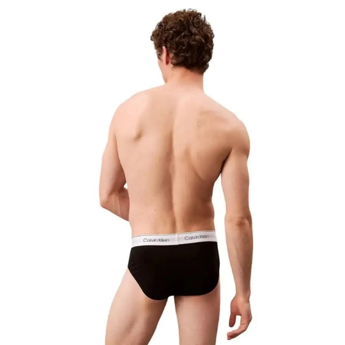 Black Calvin Klein briefs featuring a white elastic waistband for men’s underwear