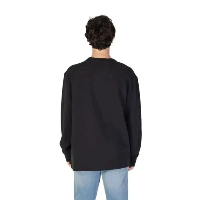 Black crewneck sweatshirt displayed from behind in Calvin Klein Jeans collection