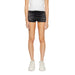 Black denim shorts styled with a white top and sneakers in Tommy Hilfiger Jeans collection