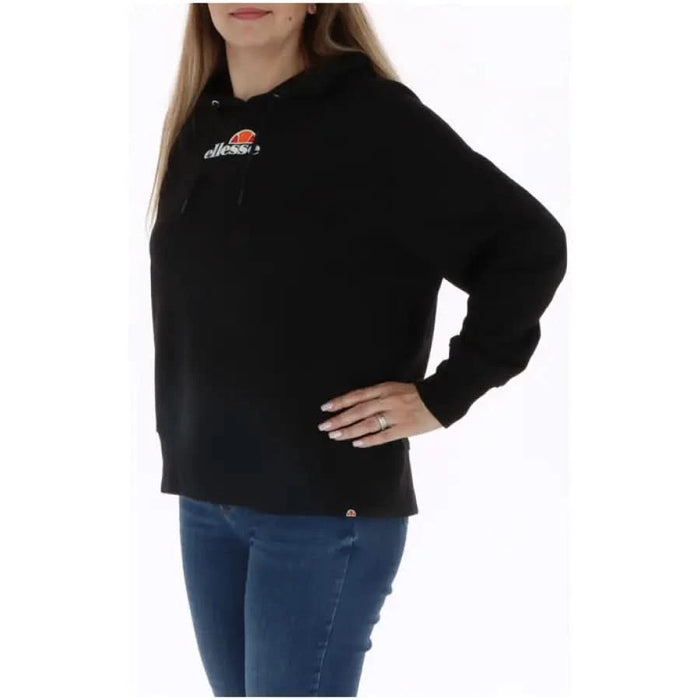 Ellesse Women Sweatshirt: Black Ellesse hoodie paired with blue jeans for a stylish look