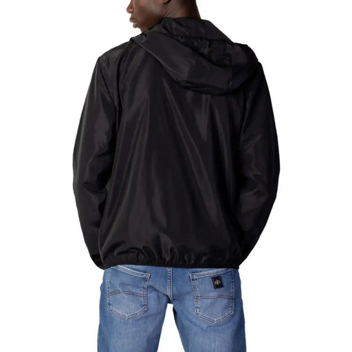 Black hooded jacket over blue jeans, viewed from behind, in Ea7 Men Blazer design