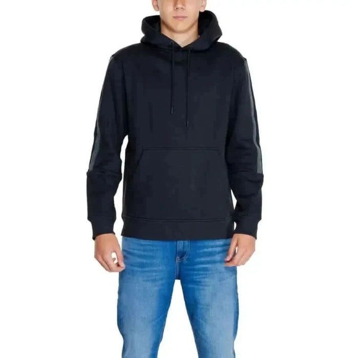 Calvin Klein Jeans Men Sweatshirt black hooded over blue jeans casual wear