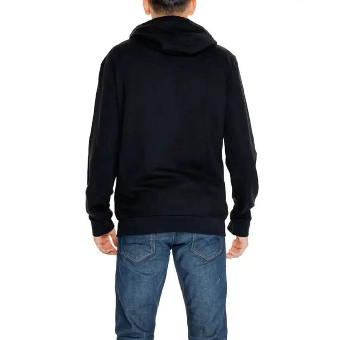 Ea7 Men Sweatshirts - Black hooded sweatshirt with blue jeans, rear view