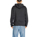 New Balance Men Sweatshirts Black hooded sweatshirt worn by a person in blue jeans rear view