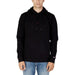 Person wearing Tommy Hilfiger black hooded sweatshirt and jeans from Tommy Hilfiger Jeans Men