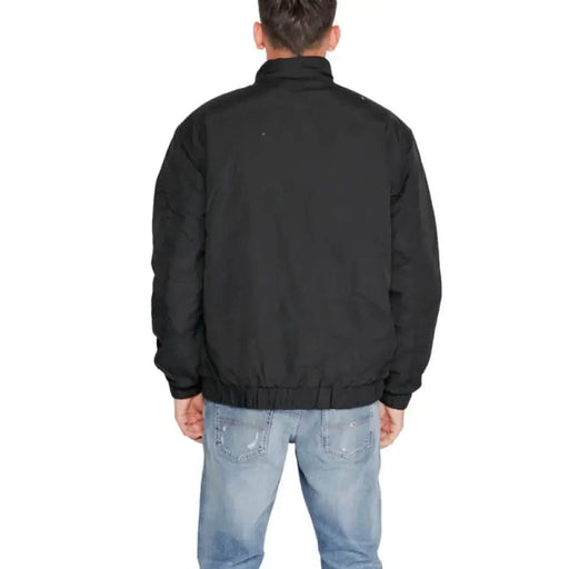 Black jacket viewed from the back, featuring Tommy Hilfiger Men Jacket design