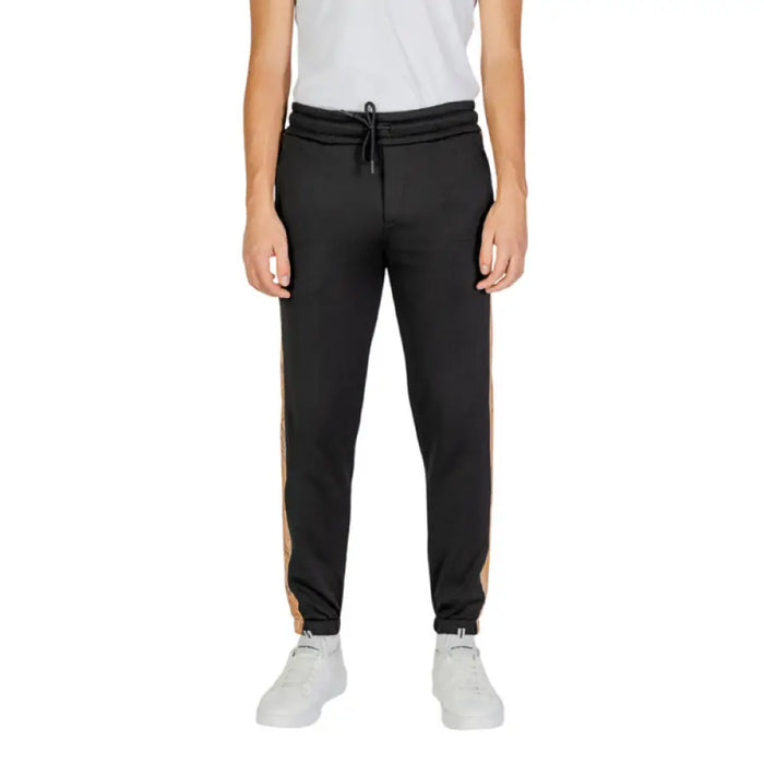 Black jogger sweatpants with tan side stripes and elastic cuffs by Alviero Martini Prima Classe