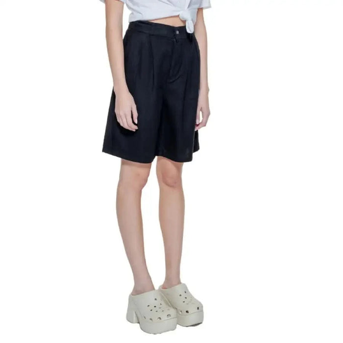 Black knee-length shorts worn with a white top and chunky white platform shoes - Only Women Short