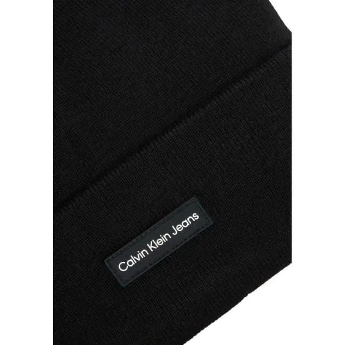 Black knit scarf with Calvin Klein Jeans label paired with Calvin Klein Men Cap