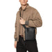 Black leather crossbody messenger bag with minimalist design from Calvin Klein