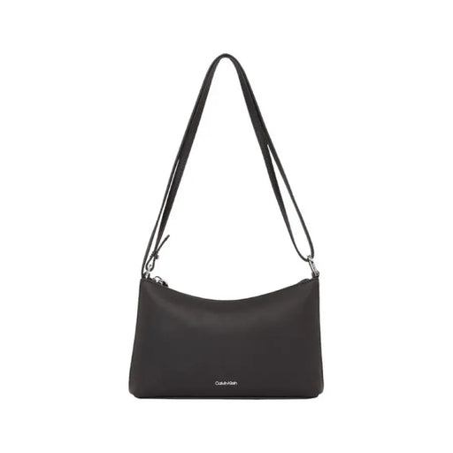 Black leather shoulder bag with long strap and Calvin Klein branding for women