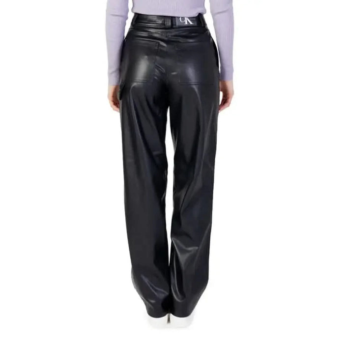 Black leather wide-leg trousers from Calvin Klein Jeans, paired with a light-colored top