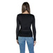 Black long-sleeved fitted top paired with blue jeans, featuring a round neck design