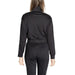 Black long-sleeved jumpsuit with belted waist displayed from the back by Calvin Klein Sport