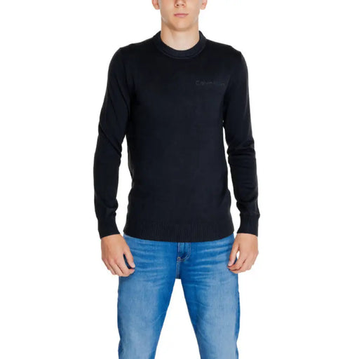 Black long-sleeved sweater over dark undershirt from Calvin Klein Jeans Knitwear