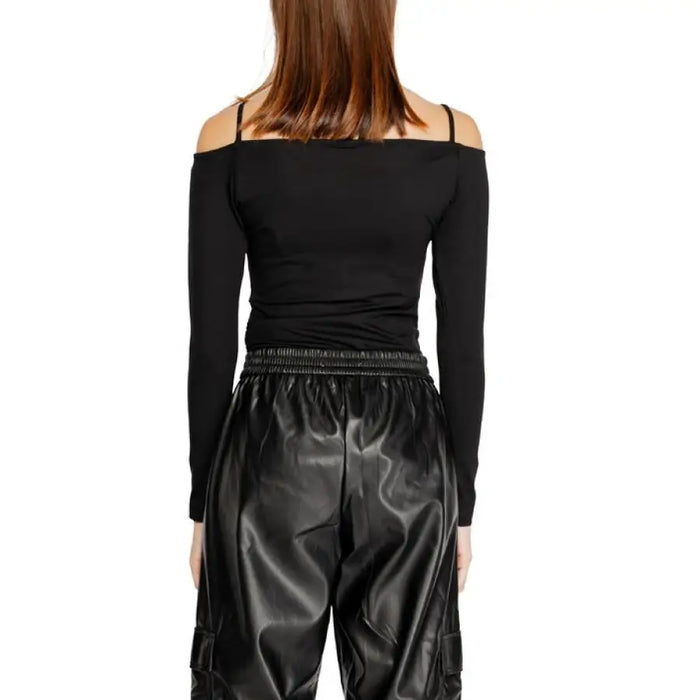 Black off-shoulder long-sleeved top paired with shiny black pants from Icon Women T-Shirt