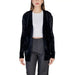 Black open-front cardigan sweater over white top and gray pants by Morgan De Toi