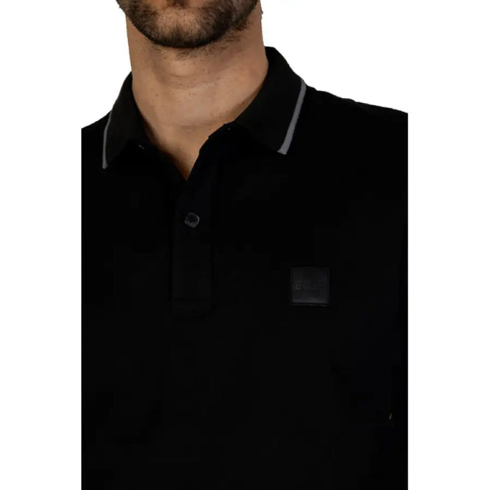 Black polo shirt with gray trim and dark square patch from Boss Spring/Summer Collection