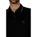 Black polo shirt with gray trim and dark square patch from Boss Spring/Summer Collection