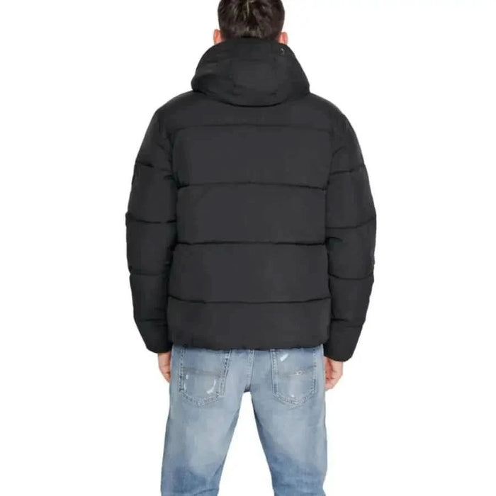 Black puffy winter jacket with hood viewed from the back by Calvin Klein