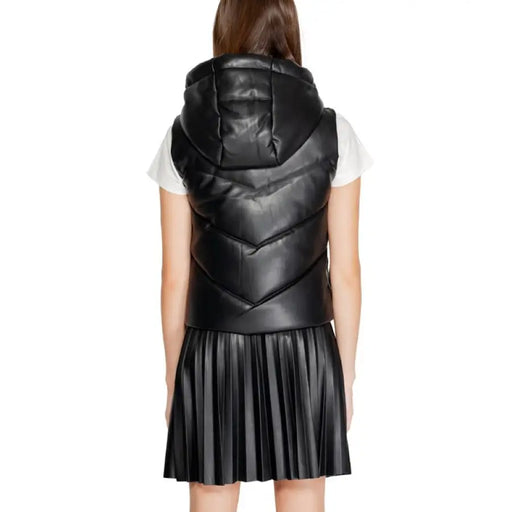 Black quilted leather vest over white shirt and pleated skirt from Morgan De Toi Women Jacket