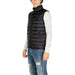 Black quilted puffer vest over white sweater and distressed jeans in Gianni Lupo Men Gilet