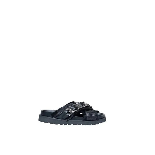 Black Cult sandal with woven straps and floral embellishments on a chunky sole