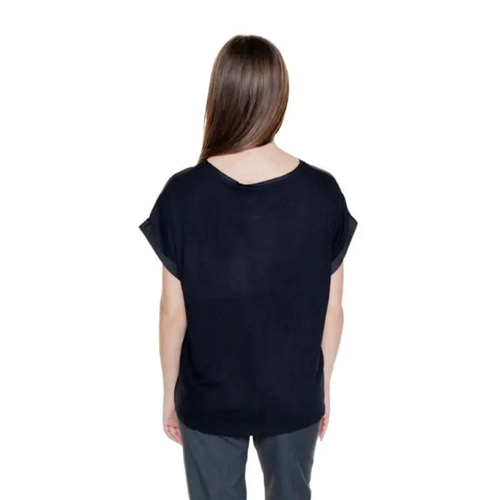 Back view of person in black short-sleeved Vila Clothes women top with long brown hair