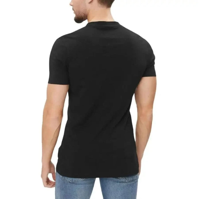 Black short-sleeved Calvin Klein Jeans T-shirt modeled from behind on a person