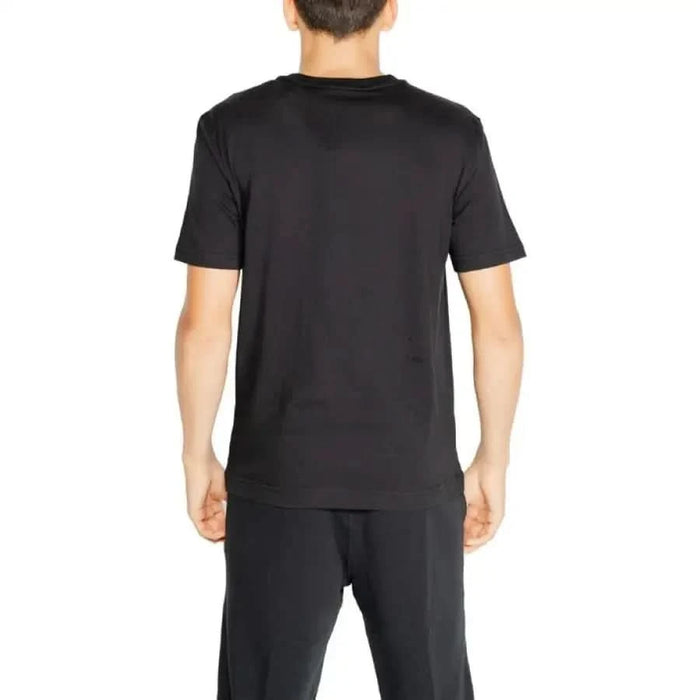 Black short-sleeved Calvin Klein Sport T-Shirt worn by a person from behind