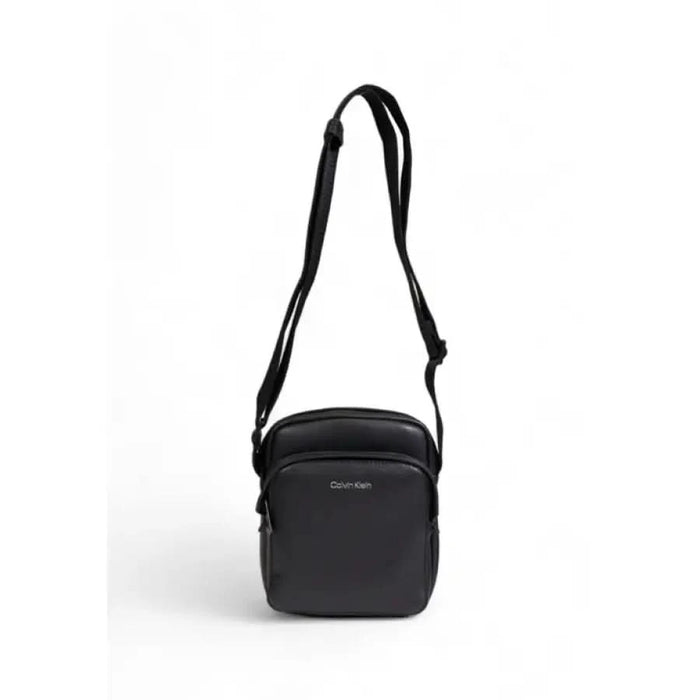 Black Calvin Klein shoulder bag featuring a long strap and zipper closure