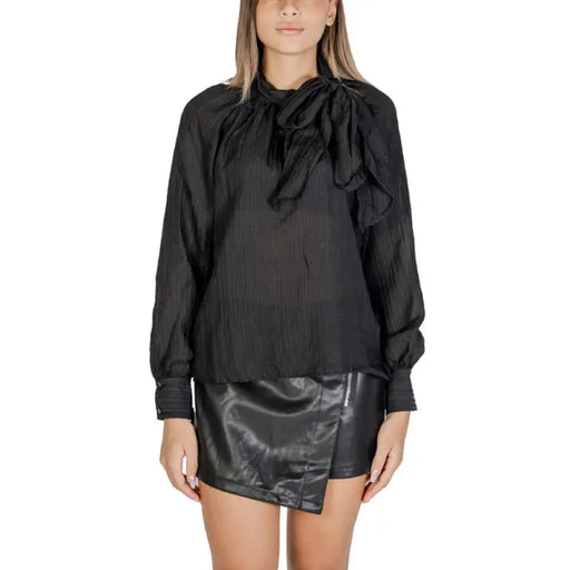 Black silk blouse with bow neckline and faux leather mini skirt by Jacqueline De Yong