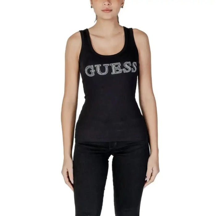 Black sleeveless tank top featuring rhinestone GUESS logo across the chest