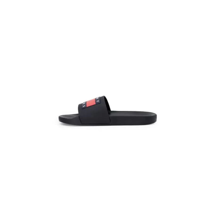 Black slide sandal with red and white logo on strap from Tommy Hilfiger Jeans