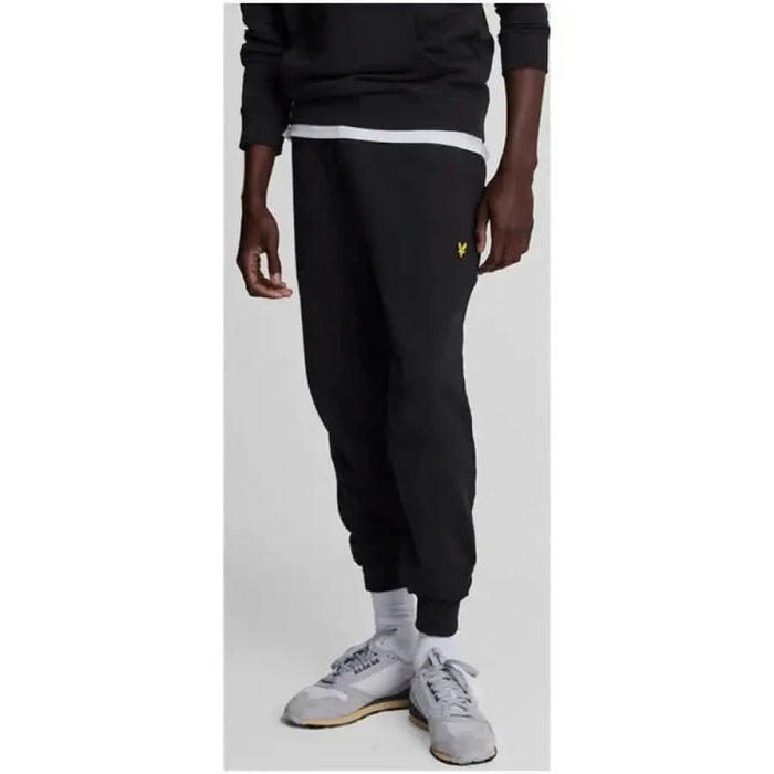 Black Lyle & Scott men’s sweatpants featuring an elastic cuff at the ankle