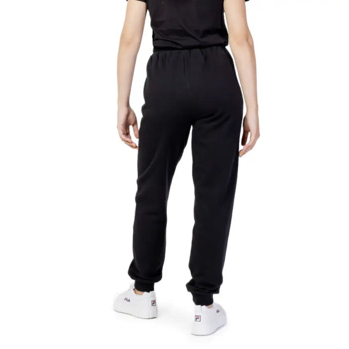 Black Fila women trousers worn by a person viewed from behind