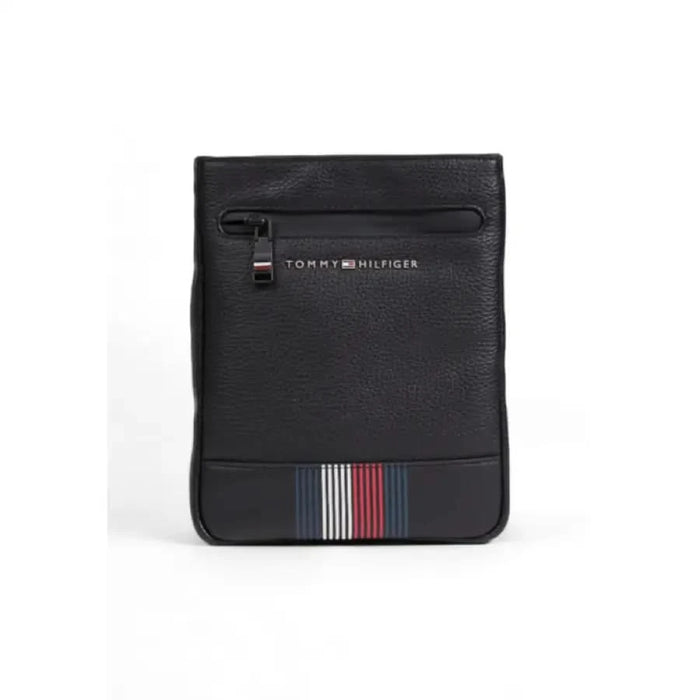 Black Tommy Hilfiger messenger bag featuring a striped accent at the bottom