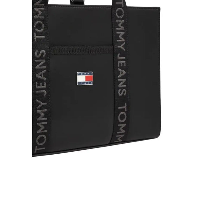 Black Tommy Jeans tote bag featuring brand logo patch suitable for women