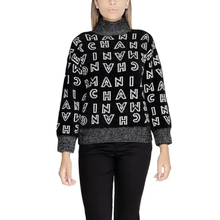 Black turtleneck sweater featuring repeating white CHANEL letters, by Armani Exchange