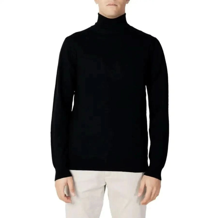 Black turtleneck sweater worn by a model from Diktat Men Knitwear collection